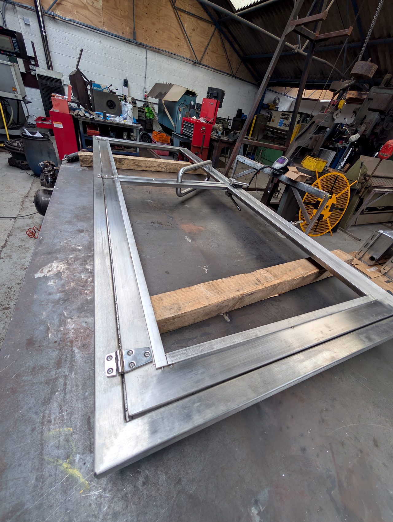 Large steel frame on a fabrication bench