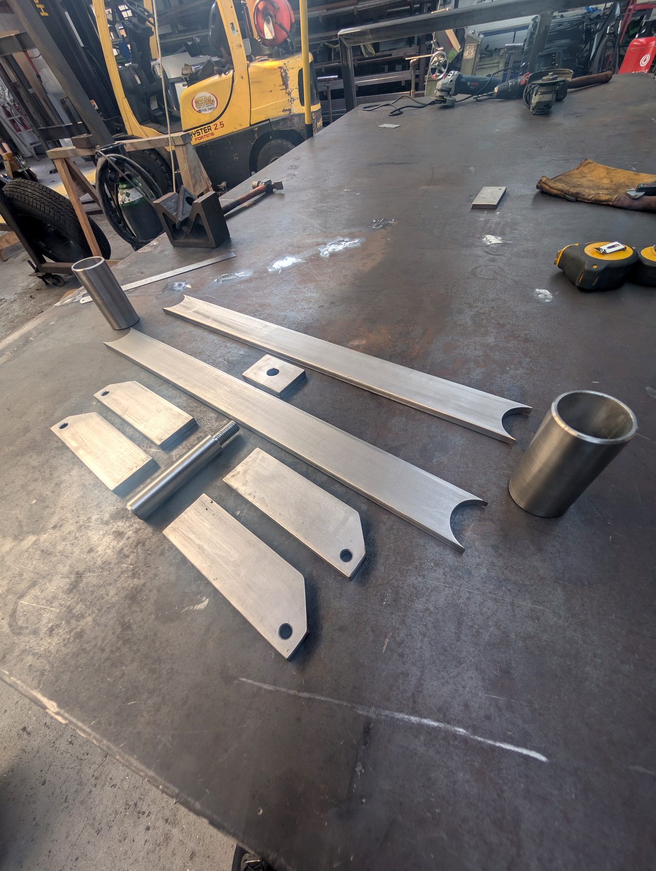 Finished fabricated metal parts on a workshop table